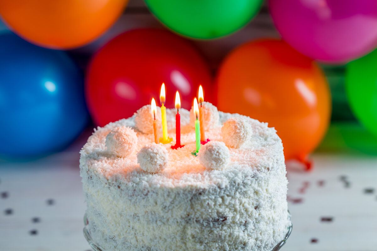 Coconut cake for birthday on old wooden table