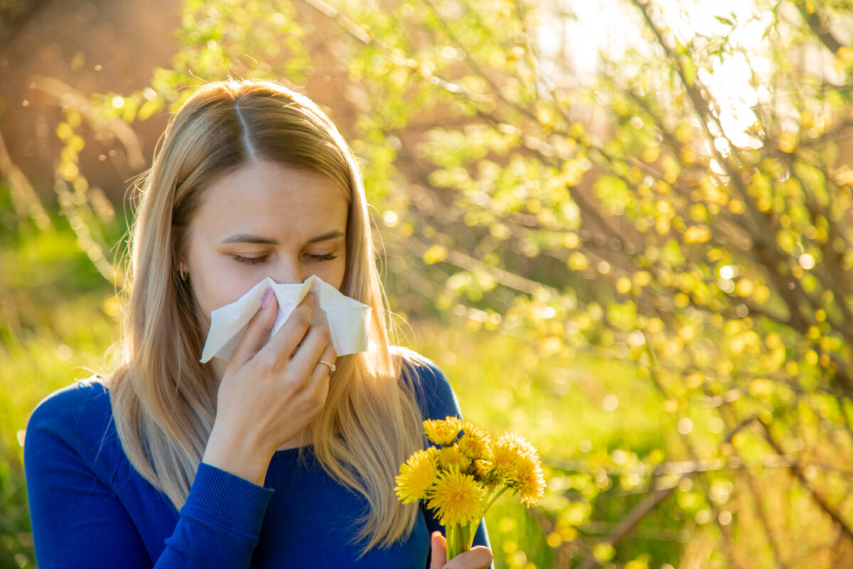 The girl is allergic to flowers in the field. Selective focus