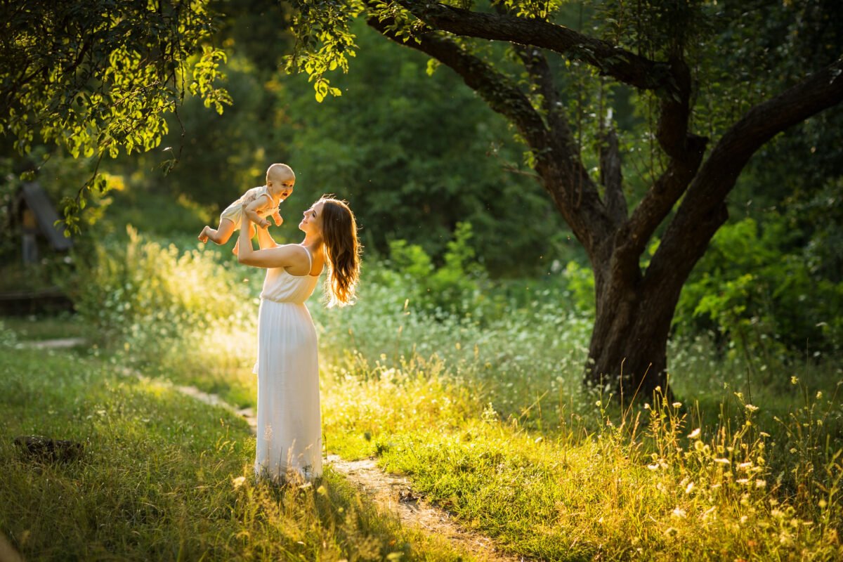 Young beautiful mother plays with her child