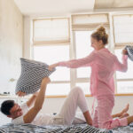 young couple having fun on bed in morning